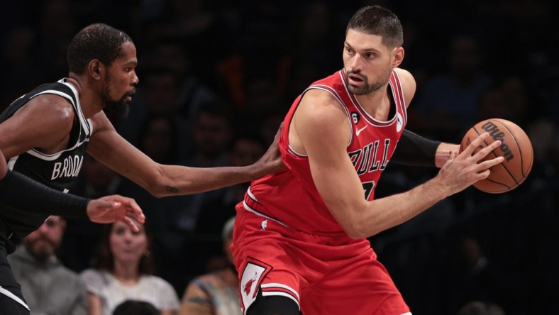 Nov 1, 2022; Brooklyn, New York, USA; Chicago Bulls center Nikola Vucevic (9) shields the ball from Brooklyn Nets forward Kevin Durant (7) during the first half at Barclays Center. Mandatory Credit: Vincent Carchietta-USA TODAY Sports