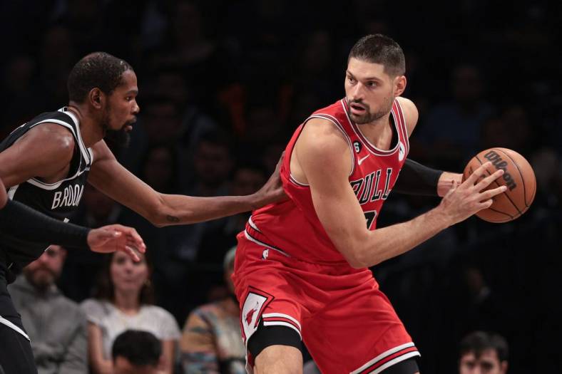 Nov 1, 2022; Brooklyn, New York, USA; Chicago Bulls center Nikola Vucevic (9) shields the ball from Brooklyn Nets forward Kevin Durant (7) during the first half at Barclays Center. Mandatory Credit: Vincent Carchietta-USA TODAY Sports