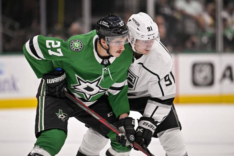 Nov 1, 2022; Dallas, Texas, USA; Dallas Stars left wing Mason Marchment (27) and Los Angeles Kings right wing Carl Grundstrom (91) battle for control of the puck during the first period at the American Airlines Center. Mandatory Credit: Jerome Miron-USA TODAY Sports