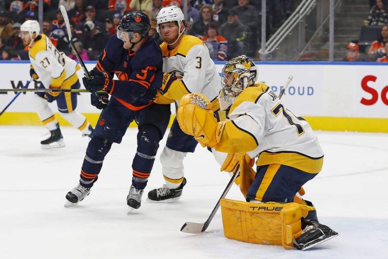 Nov 1, 2022; Edmonton, Alberta, CAN; Edmonton Oilers forward Warren Foegele (37) battles for position with Nashville Predators defensemen Jeremy Lauzon (3) in front of goaltender Juuse Saros (74) during the first period at Rogers Place. Mandatory Credit: Perry Nelson-USA TODAY Sports
