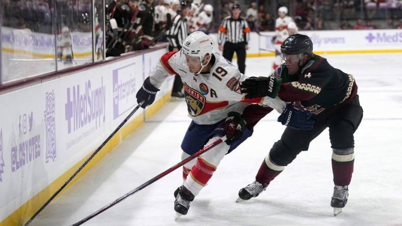 Nov 1, 2022; Tempe, Arizona, USA; Florida Panthers left wing Matthew Tkachuk (19) skates against Arizona Coyotes defenseman Juuso Valimaki (4) during the first period at Mullett Arena. Mandatory Credit: Joe Camporeale-USA TODAY Sports