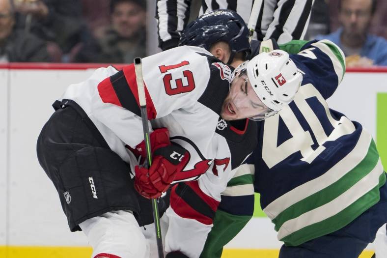 Nov 1, 2022; Vancouver, British Columbia, CAN; New Jersey Devils forward Nico Hischier (13) faces off against Vancouver Canucks forward Elias Pettersson (40) in the second period at Rogers Arena. Mandatory Credit: Bob Frid-USA TODAY Sports