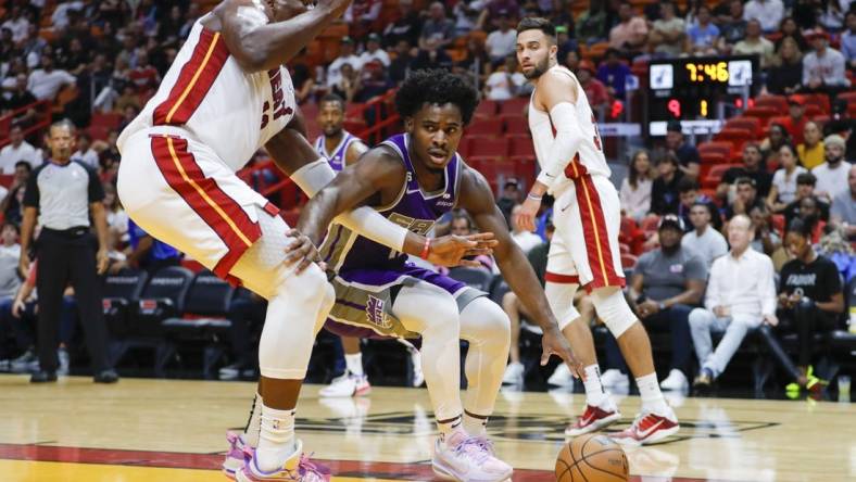 Nov 2, 2022; Miami, Florida, USA; Sacramento Kings guard Davion Mitchell (15) dribbles as Miami Heat center Bam Adebayo (13) defends during the first quarter at FTX Arena. Mandatory Credit: Sam Navarro-USA TODAY Sports