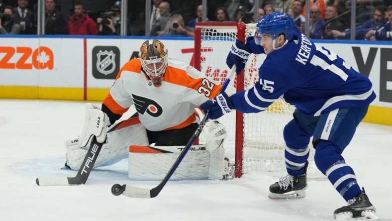Nov 2, 2022; Toronto, Ontario, CAN; Toronto Maple Leafs center Alexander Kerfoot (15) passes in front of Philadelphia Flyers goaltender Felix Sandstrom (32) during the first period at Scotiabank Arena. Mandatory Credit: Nick Turchiaro-USA TODAY Sports