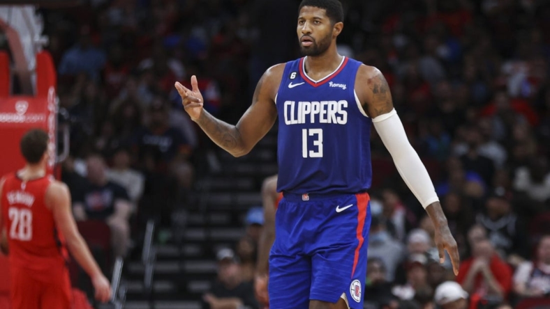 Nov 2, 2022; Houston, Texas, USA; Los Angeles Clippers guard Paul George (13) reacts after a basket by forward Marcus Morris Sr. (not pictured) during the fourth quarter against the Houston Rockets at Toyota Center. Mandatory Credit: Troy Taormina-USA TODAY Sports