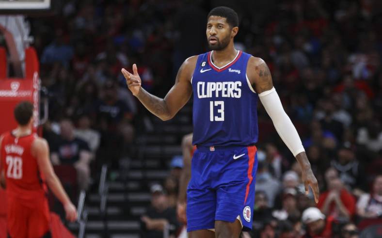 Nov 2, 2022; Houston, Texas, USA; Los Angeles Clippers guard Paul George (13) reacts after a basket by forward Marcus Morris Sr. (not pictured) during the fourth quarter against the Houston Rockets at Toyota Center. Mandatory Credit: Troy Taormina-USA TODAY Sports