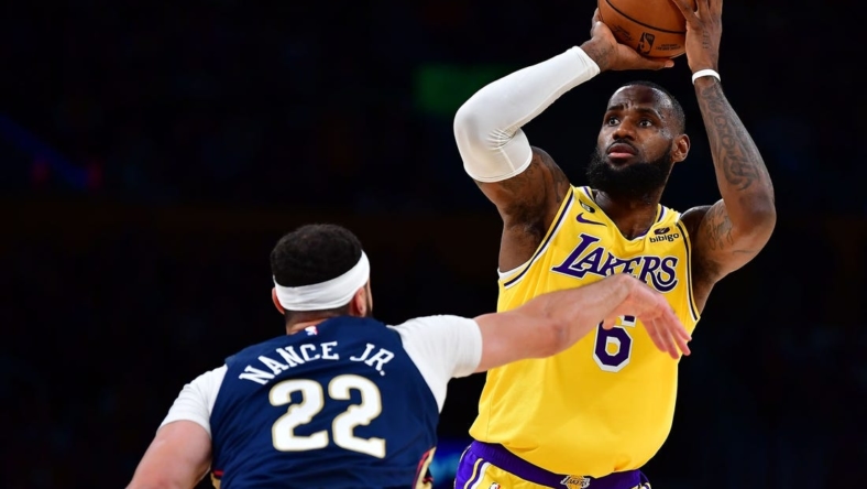 Nov 2, 2022; Los Angeles, California, USA; Los Angeles Lakers forward LeBron James (6) shoots against New Orleans Pelicans forward Larry Nance Jr. (22) during the first half at Crypto.com Arena. Mandatory Credit: Gary A. Vasquez-USA TODAY Sports