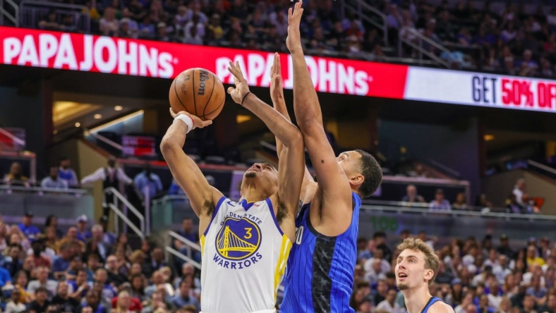 Nov 3, 2022; Orlando, Florida, USA; Golden State Warriors center James Wiseman (33) goes to the basket in front of Orlando Magic guard Jalen Suggs (4) during the second quarter at Amway Center. Mandatory Credit: Mike Watters-USA TODAY Sports