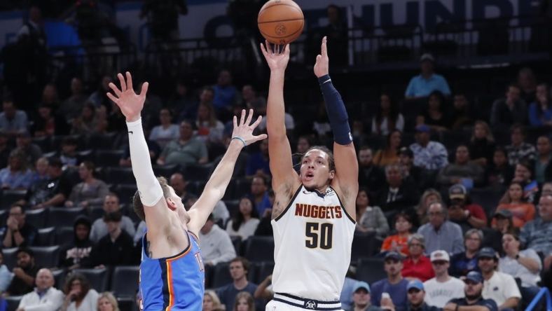 Nov 3, 2022; Oklahoma City, Oklahoma, USA; Denver Nuggets forward Aaron Gordon (50) is defended by Oklahoma City Thunder center Mike Muscala (33) on a three point shot during the second quarter at Paycom Center. Mandatory Credit: Alonzo Adams-USA TODAY Sports