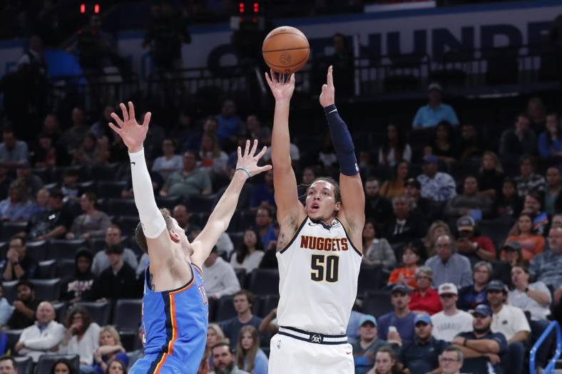 Nov 3, 2022; Oklahoma City, Oklahoma, USA; Denver Nuggets forward Aaron Gordon (50) is defended by Oklahoma City Thunder center Mike Muscala (33) on a three point shot during the second quarter at Paycom Center. Mandatory Credit: Alonzo Adams-USA TODAY Sports