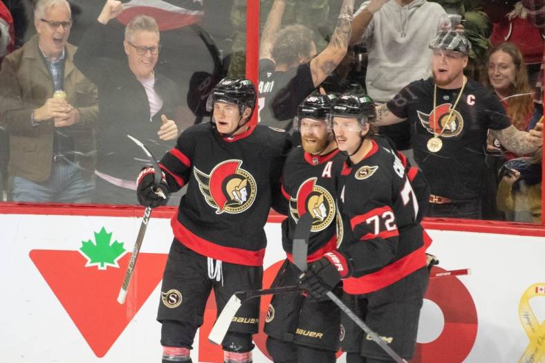 Nov 3, 2022; Ottawa, Ontario, CAN; Ottawa Senators left wing Tim Stutzle (18-left) celebrates with team his goal scored in the third period against the Vegas Golden Knights at the Canadian Tire Centre. Mandatory Credit: Marc DesRosiers-USA TODAY Sports