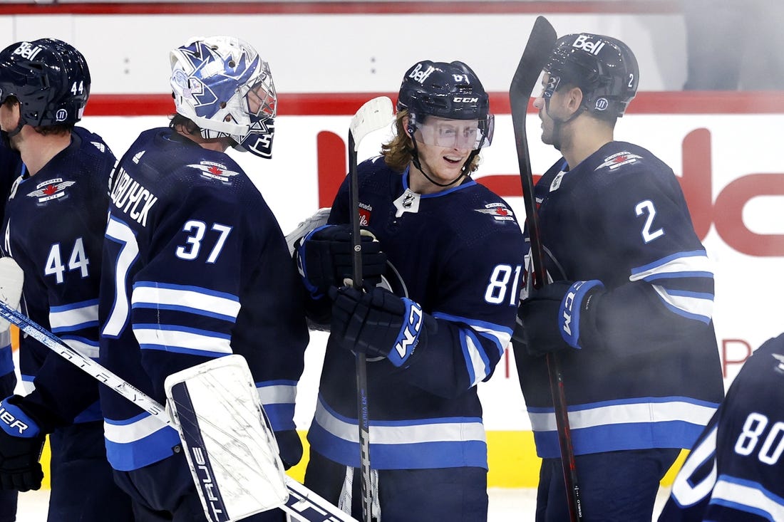 Nov 3, 2022; Winnipeg, Manitoba, CAN; Winnipeg Jets left wing Kyle Connor (81) celebrates his overtime goal with Winnipeg Jets goaltender Connor Hellebuyck (37) and Winnipeg Jets defenseman Dylan DeMelo (2) against the Montreal Canadiens at Canada Life Centre. Mandatory Credit: James Carey Lauder-USA TODAY Sports