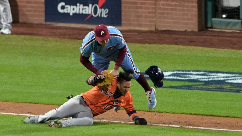 Nov 3, 2022; Philadelphia, Pennsylvania, USA;  Philadelphia Phillies first baseman Rhys Hoskins (17) makes the tag on Houston Astros first baseman Yuli Gurriel (10) in a run down during the seventh inning in game five of the 2022 World Series at Citizens Bank Park. Mandatory Credit: John Geliebter-USA TODAY Sports