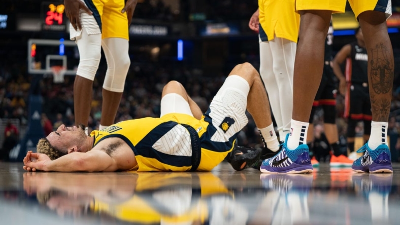 Nov 4, 2022; Indianapolis, Indiana, USA; Indiana Pacers guard Chris Duarte (3) lays on the ground after falling during a game against the Miami Heat at Gainbridge Fieldhouse. Mandatory Credit: Jacob Musselman-USA TODAY Sports
