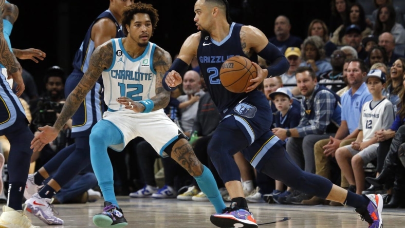 Nov 4, 2022; Memphis, Tennessee, USA; Memphis Grizzlies forward Dillon Brooks (24) dribbles as Charlotte Hornets guard Kelly Oubre Jr. (12) defends during the first half at FedExForum. Mandatory Credit: Petre Thomas-USA TODAY Sports