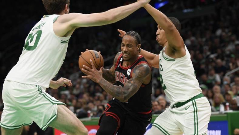 Nov 4, 2022; Boston, Massachusetts, USA;  Chicago Bulls forward DeMar DeRozan (11) controls the ball while Boston Celtics center Luke Kornet (40) and forward Grant Williams (12) defend during the second half at TD Garden. Mandatory Credit: Bob DeChiara-USA TODAY Sports