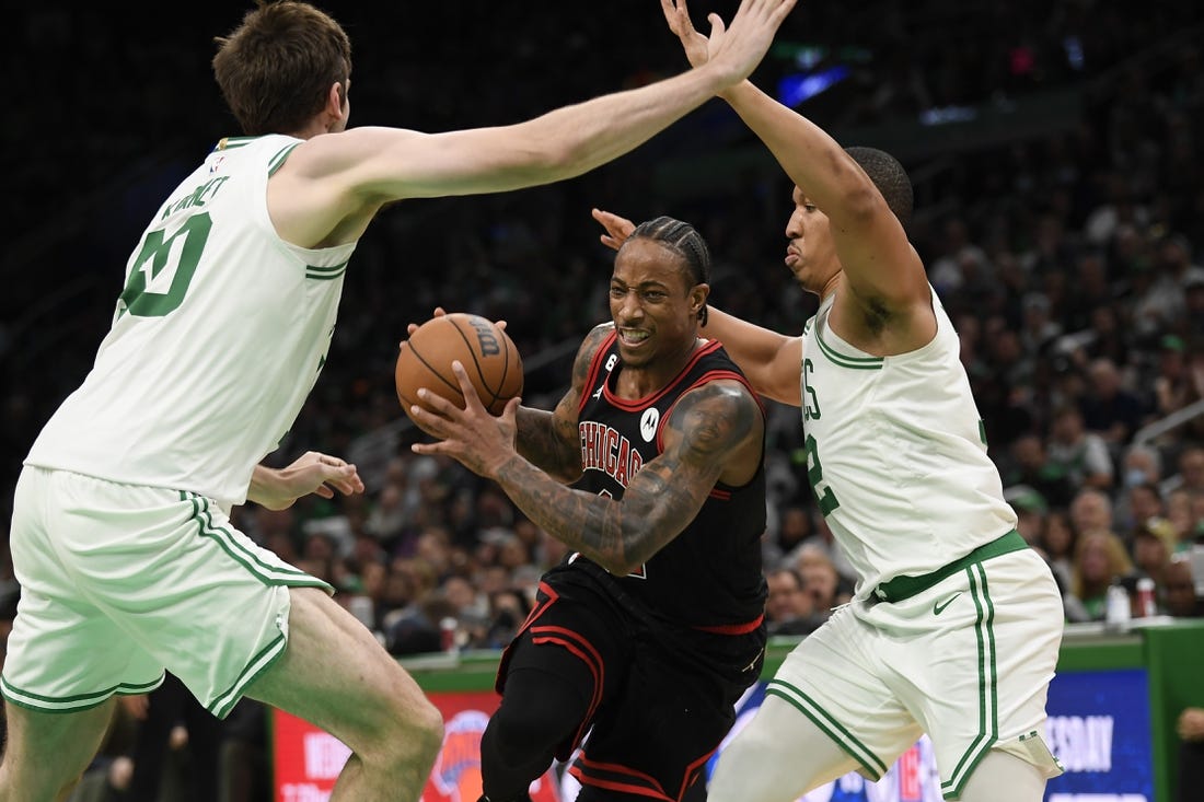 Nov 4, 2022; Boston, Massachusetts, USA;  Chicago Bulls forward DeMar DeRozan (11) controls the ball while Boston Celtics center Luke Kornet (40) and forward Grant Williams (12) defend during the second half at TD Garden. Mandatory Credit: Bob DeChiara-USA TODAY Sports