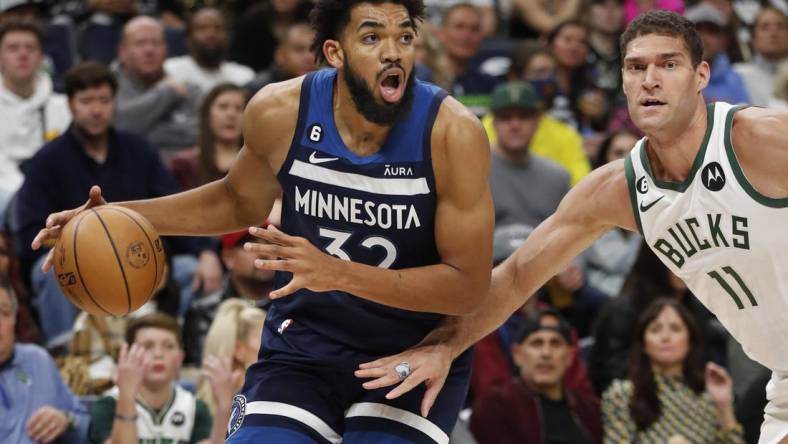 Nov 4, 2022; Minneapolis, Minnesota, USA; Minnesota Timberwolves center Karl-Anthony Towns (32) works around Milwaukee Bucks center Brook Lopez (11) in the third quarter at Target Center. Mandatory Credit: Bruce Kluckhohn-USA TODAY Sports