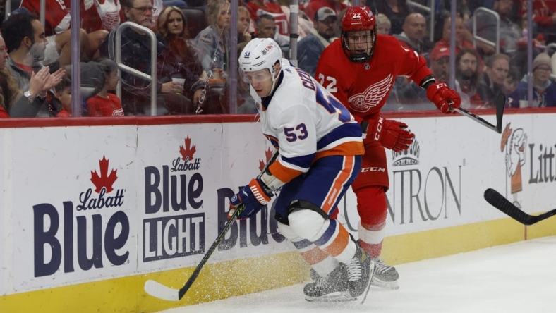 Nov 5, 2022; Detroit, Michigan, USA;  New York Islanders center Casey Cizikas (53) and Detroit Red Wings right wing Matt Luff (22) battle for the puck in the first period at Little Caesars Arena. Mandatory Credit: Rick Osentoski-USA TODAY Sports