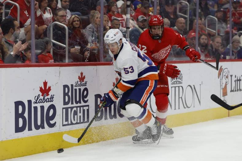 Nov 5, 2022; Detroit, Michigan, USA;  New York Islanders center Casey Cizikas (53) and Detroit Red Wings right wing Matt Luff (22) battle for the puck in the first period at Little Caesars Arena. Mandatory Credit: Rick Osentoski-USA TODAY Sports