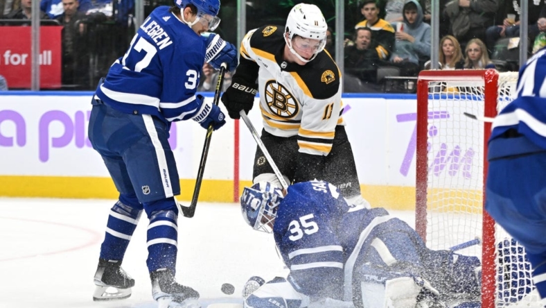 Nov 5, 2022; Toronto, Ontario, CAN; Toronto Maple Leafs goalie Ilya Samsonov (35) makes a save against Boston Bruins forward Trent Frederic (11) as Leafs defenseman Timothy Liljegren (37) covers the rebound in the first period at Scotiabank Arena. Mandatory Credit: Dan Hamilton-USA TODAY Sports