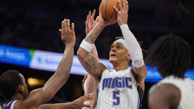 Nov 5, 2022; Orlando, Florida, USA;  Orlando Magic forward Paolo Banchero (5) shoots the ball against the Sacramento Kings in the fourth quarter at Amway Center. Mandatory Credit: Nathan Ray Seebeck-USA TODAY Sports