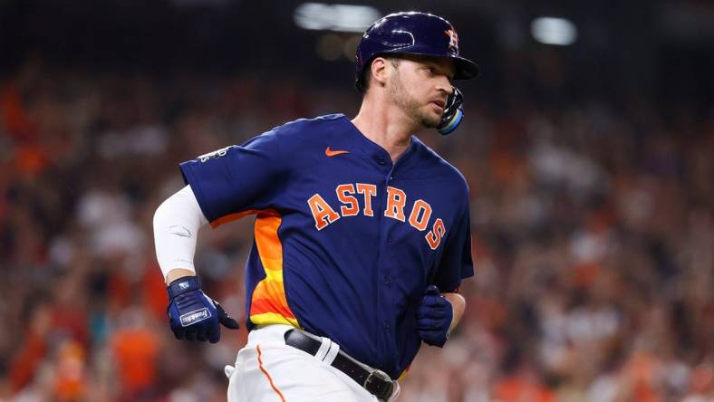 Nov 5, 2022; Houston, Texas, USA; Houston Astros first baseman Trey Mancini (26) runs to first after hitting a single against the Philadelphia Phillies during the third inning in game six of the 2022 World Series at Minute Maid Park. Mandatory Credit: Troy Taormina-USA TODAY Sports