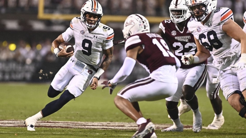 Nov 5, 2022; Starkville, Mississippi, USA; Auburn Tigers quarterback Robby Ashford (9) is defended by Mississippi State Bulldogs safety Collin Duncan (19) during the second quarter at Davis Wade Stadium at Scott Field. Mandatory Credit: Matt Bush-USA TODAY Sports