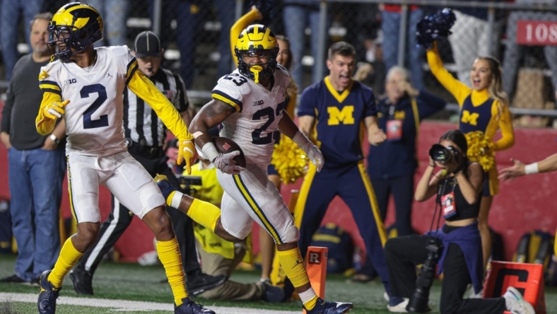 Nov 5, 2022; Piscataway, New Jersey, USA; Michigan Wolverines linebacker Michael Barrett (23) returns an interception for a touchdown during the second half against the Rutgers Scarlet Knights at SHI Stadium. Mandatory Credit: Vincent Carchietta-USA TODAY Sports