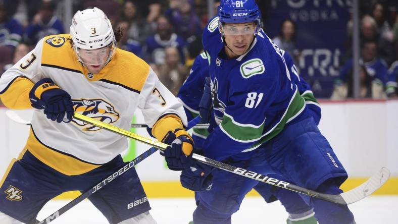 Nov 5, 2022; Vancouver, British Columbia, CAN;  Nashville Predators defenseman Jeremy Lauzon (3) and Vancouver Canucks forward Dakota Joshua (81) vie for the puck during the second period at Rogers Arena. Mandatory Credit: Anne-Marie Sorvin-USA TODAY Sports