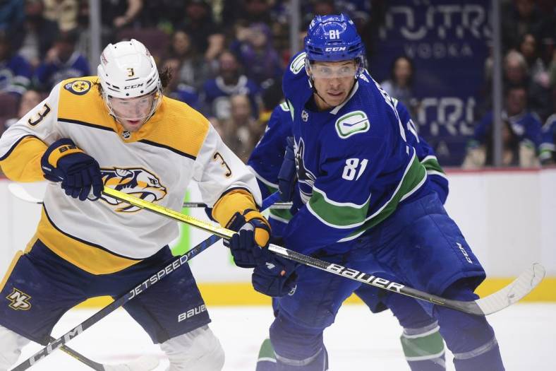 Nov 5, 2022; Vancouver, British Columbia, CAN;  Nashville Predators defenseman Jeremy Lauzon (3) and Vancouver Canucks forward Dakota Joshua (81) vie for the puck during the second period at Rogers Arena. Mandatory Credit: Anne-Marie Sorvin-USA TODAY Sports