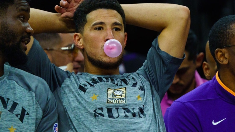 Nov 5, 2022; Phoenix, Arizona, USA; Phoenix Suns guard Devin Booker (1) blows a bubble between plays during the second half against the Portland Trail Blazers at Footprint Center. Mandatory Credit: Allan Henry-USA TODAY Sports
