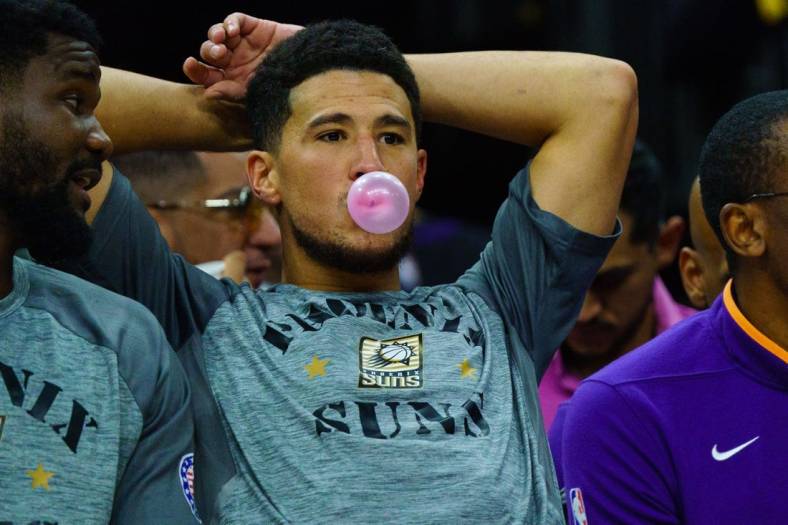 Nov 5, 2022; Phoenix, Arizona, USA; Phoenix Suns guard Devin Booker (1) blows a bubble between plays during the second half against the Portland Trail Blazers at Footprint Center. Mandatory Credit: Allan Henry-USA TODAY Sports
