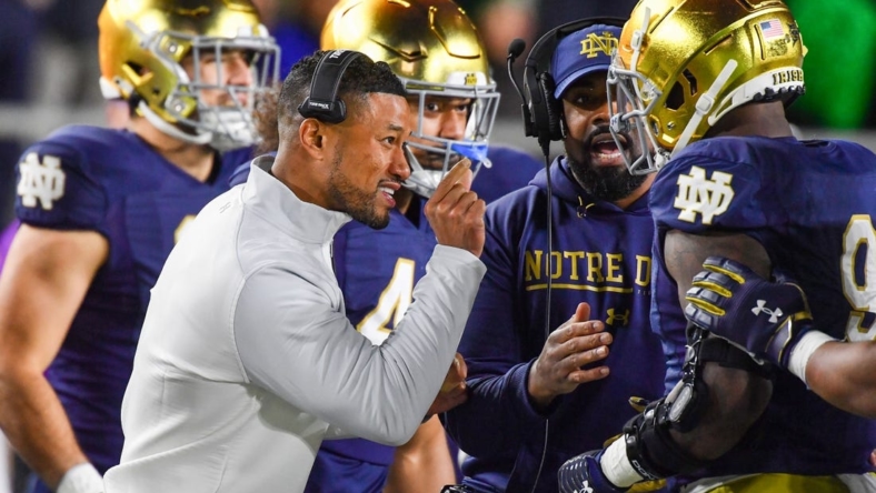 Nov 5, 2022; South Bend, Indiana, USA; Notre Dame Fighting Irish head coach Marcus Freeman talks to defensive lineman Justin Ademilola (9) in the first quarter against the Clemson Tigers at Notre Dame Stadium. Mandatory Credit: Matt Cashore-USA TODAY Sports