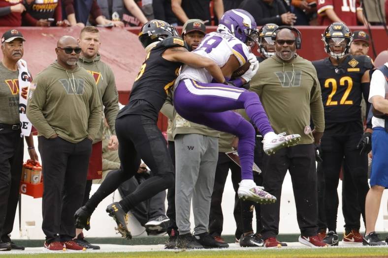 Nov 6, 2022; Landover, Maryland, USA; Minnesota Vikings wide receiver Justin Jefferson (18) catches a pass in front of Washington Commanders cornerback Benjamin St-Juste (25) during the first quarter at FedExField. Mandatory Credit: Geoff Burke-USA TODAY Sports