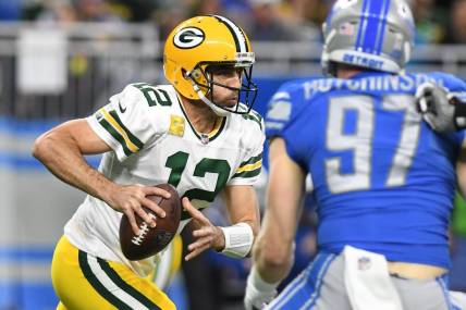 Nov 6, 2022; Detroit, Michigan, USA; Green Bay Packers quarterback Aaron Rodgers (12) rolls out of the pocket against the Detroit Lions in the first quarter at Ford Field. Mandatory Credit: Lon Horwedel-USA TODAY Sports