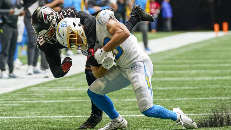 Nov 6, 2022; Atlanta, Georgia, USA; Los Angeles Chargers wide receiver Michael Bandy (83) is tackled from behind by Atlanta Falcons cornerback Isaiah Oliver (26) during the first half at Mercedes-Benz Stadium. Mandatory Credit: Dale Zanine-USA TODAY Sports