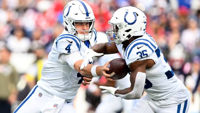 Nov 6, 2022; Foxborough, Massachusetts, USA; Indianapolis Colts quarterback Sam Ehlinger (4) hands the ball off to running back Deon Jackson (35) during the first half at Gillette Stadium. Mandatory Credit: Brian Fluharty-USA TODAY Sports