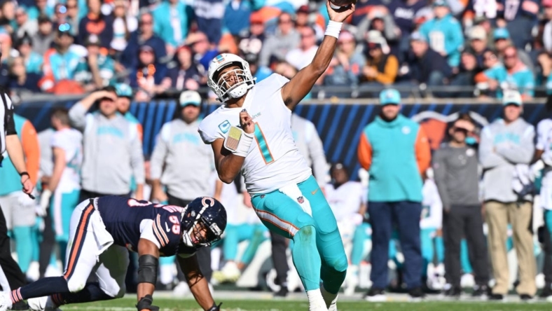Nov 6, 2022; Chicago, Illinois, USA;  Miami Dolphins quarterback Tua Tagovailoa (1) makes a pass after avoiding a sack in the second quarter against the Chicago Bears at Soldier Field. Mandatory Credit: Jamie Sabau-USA TODAY Sports