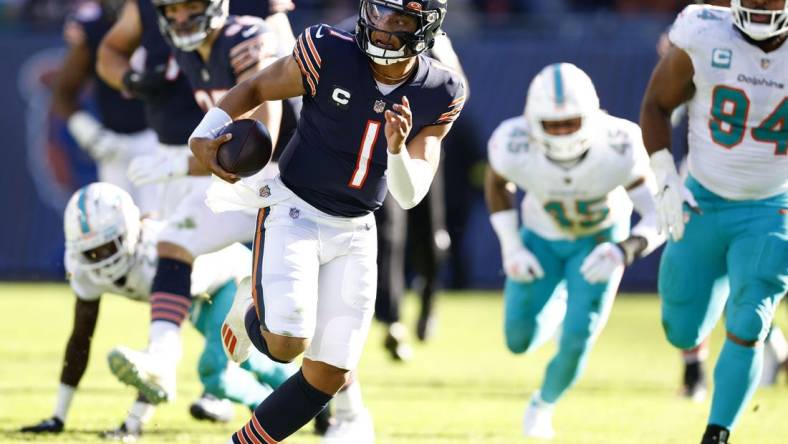 Nov 6, 2022; Chicago, Illinois, USA; Chicago Bears quarterback Justin Fields (1) rushes the ball for a touchdown against the Miami Dolphins during the second half at Soldier Field. Mandatory Credit: Mike Dinovo-USA TODAY Sports