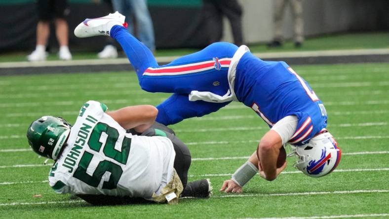 Nov 6, 2022; East Rutherford, NJ, USA; 
New York Jets defensive end Jermaine Johnson (52) takes down Buffalo Bills quarterback Josh Allen (17) in the 4th quarter at MetLife Stadium. Mandatory Credit: Robert Deutsch-USA TODAY Sports