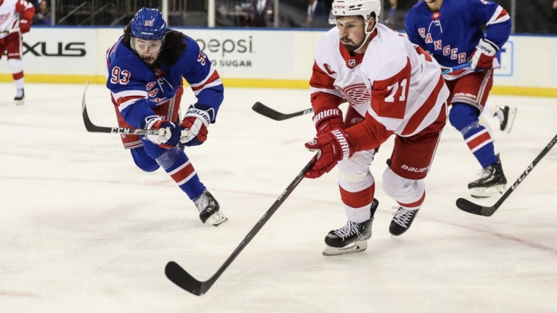 Nov 6, 2022; New York, New York, USA;  New York Rangers center Mika Zibanejad (93) and Detroit Red Wings center Dylan Larkin (71) battle for the puck in the first period at Madison Square Garden. Mandatory Credit: Wendell Cruz-USA TODAY Sports