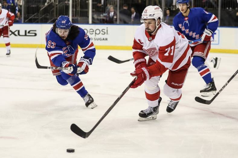 Nov 6, 2022; New York, New York, USA;  New York Rangers center Mika Zibanejad (93) and Detroit Red Wings center Dylan Larkin (71) battle for the puck in the first period at Madison Square Garden. Mandatory Credit: Wendell Cruz-USA TODAY Sports