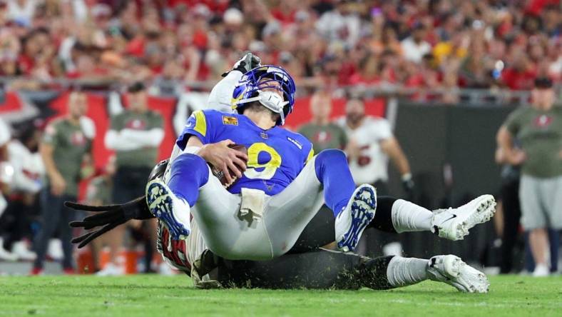 Nov 6, 2022; Tampa, Florida, USA;  Los Angeles Rams quarterback Matthew Stafford (9) is sacked by Tampa Bay Buccaneers defensive tackle Rakeem Nunez-Roches (56) in the third quarter at Raymond James Stadium. Mandatory Credit: Nathan Ray Seebeck-USA TODAY Sports