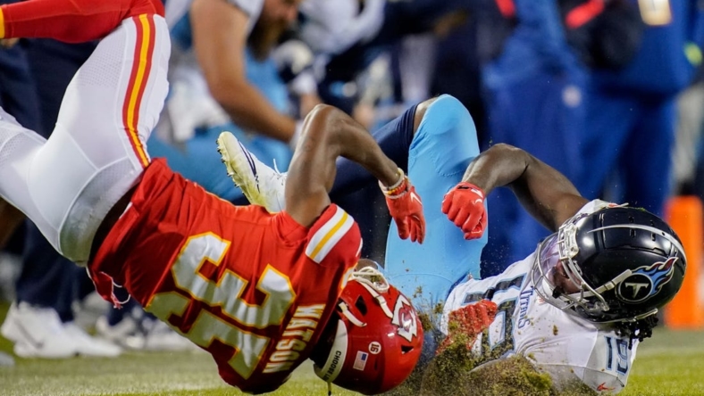 Nov 6, 2022; Kansas City, Missouri, USA; Kansas City Chiefs cornerback Jaylen Watson (35) is injured after breaking up a pass intended for Tennessee Titans wide receiver Chris Conley (19) during the second quarter at GEHA Field at Arrowhead Stadium. Mandatory Credit: George Walker IV / Tennessean.com