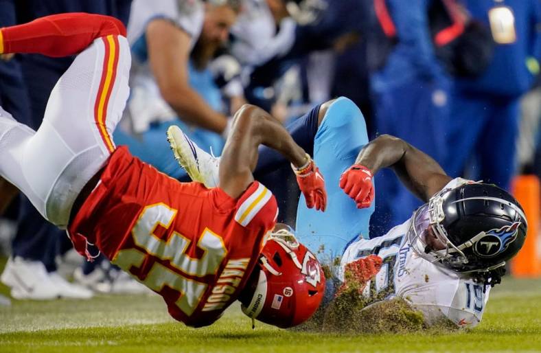 Nov 6, 2022; Kansas City, Missouri, USA; Kansas City Chiefs cornerback Jaylen Watson (35) is injured after breaking up a pass intended for Tennessee Titans wide receiver Chris Conley (19) during the second quarter at GEHA Field at Arrowhead Stadium. Mandatory Credit: George Walker IV / Tennessean.com