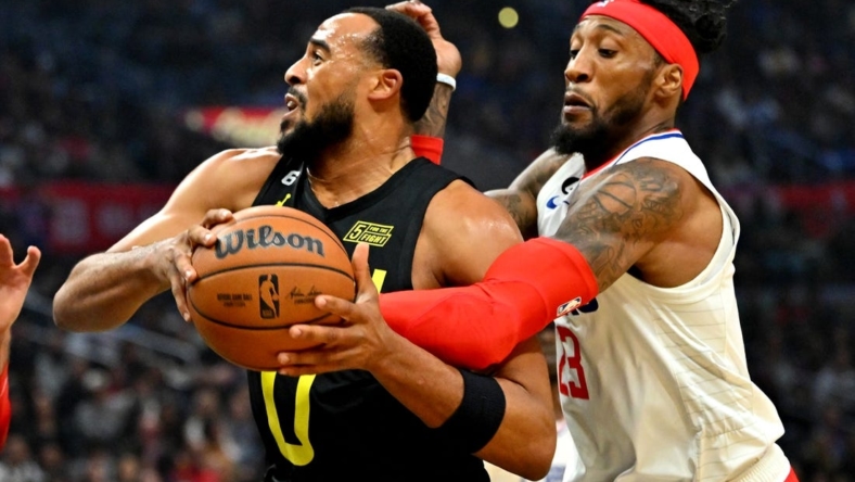 Nov 6, 2022; Los Angeles, California, USA;  Utah Jazz guard Talen Horton-Tucker (0) is fouled by Los Angeles Clippers forward Robert Covington (23) in the first half at Crypto.com Arena. Mandatory Credit: Jayne Kamin-Oncea-USA TODAY Sports