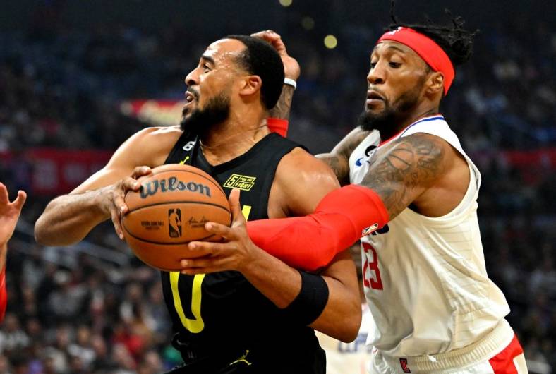 Nov 6, 2022; Los Angeles, California, USA;  Utah Jazz guard Talen Horton-Tucker (0) is fouled by Los Angeles Clippers forward Robert Covington (23) in the first half at Crypto.com Arena. Mandatory Credit: Jayne Kamin-Oncea-USA TODAY Sports