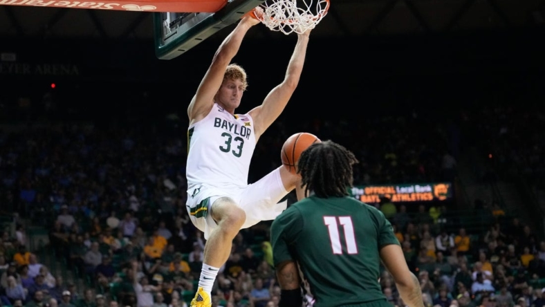Nov 7, 2022; Waco, Texas, USA; Baylor Bears forward Caleb Lohner (33) dunks the ball against Mississippi Valley State Delta Devils guard Terry Collins (11) during the first half at Ferrell Center. Mandatory Credit: Chris Jones-USA TODAY Sports
