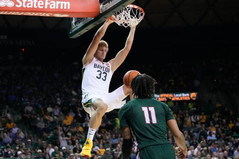 Nov 7, 2022; Waco, Texas, USA; Baylor Bears forward Caleb Lohner (33) dunks the ball against Mississippi Valley State Delta Devils guard Terry Collins (11) during the first half at Ferrell Center. Mandatory Credit: Chris Jones-USA TODAY Sports